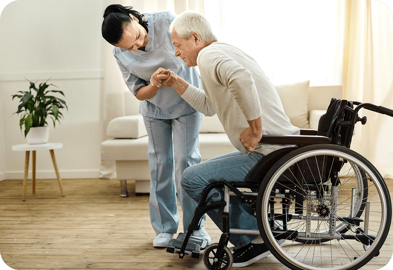 Caregiver assisting elderly man in wheelchair.